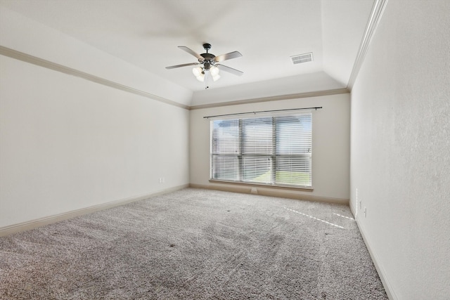 carpeted spare room featuring visible vents, baseboards, crown molding, and lofted ceiling