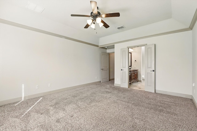 unfurnished bedroom with visible vents, baseboards, light colored carpet, ensuite bathroom, and a ceiling fan