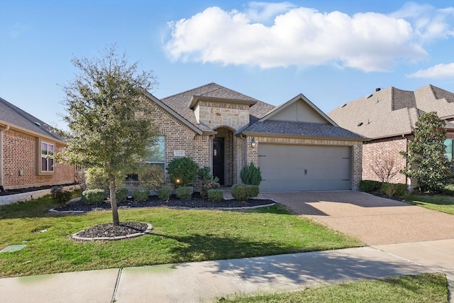 view of front of house with a front yard, roof with shingles, an attached garage, concrete driveway, and brick siding