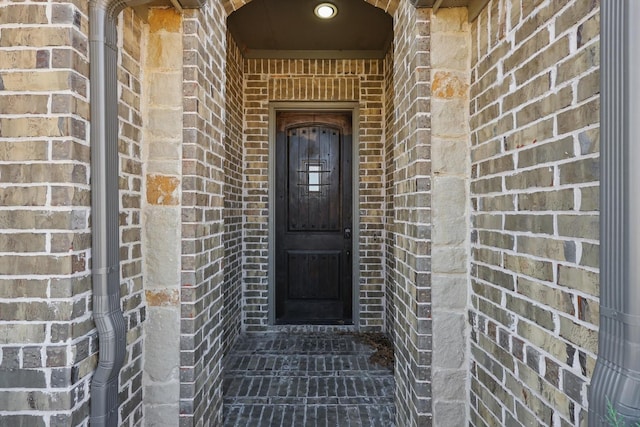 property entrance with brick siding