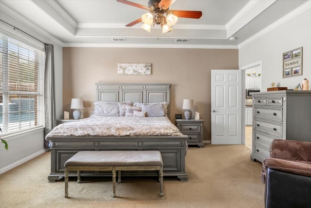 bedroom featuring visible vents, multiple windows, and a tray ceiling