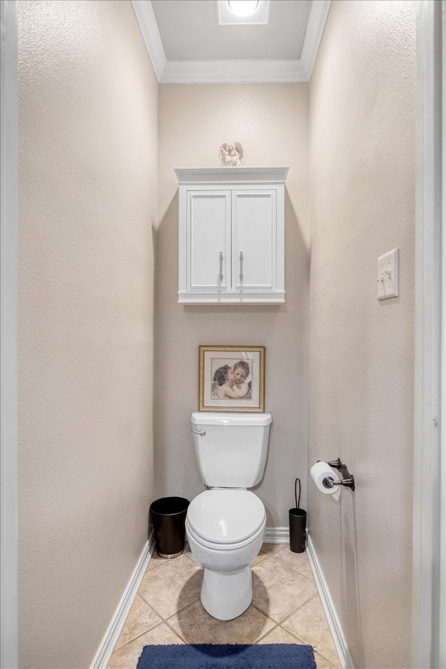 bathroom with tile patterned floors, toilet, baseboards, and ornamental molding