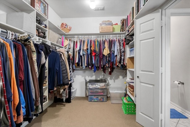 walk in closet featuring visible vents and carpet