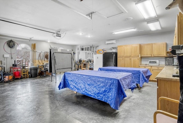 garage featuring an AC wall unit, a garage door opener, and freestanding refrigerator