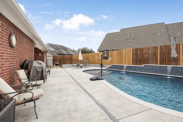 view of swimming pool with a fenced in pool, area for grilling, a fenced backyard, and a patio area