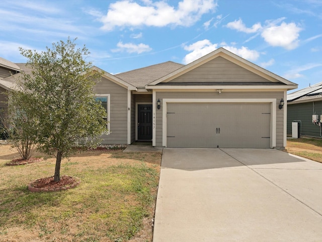 single story home featuring an attached garage, driveway, and a front lawn