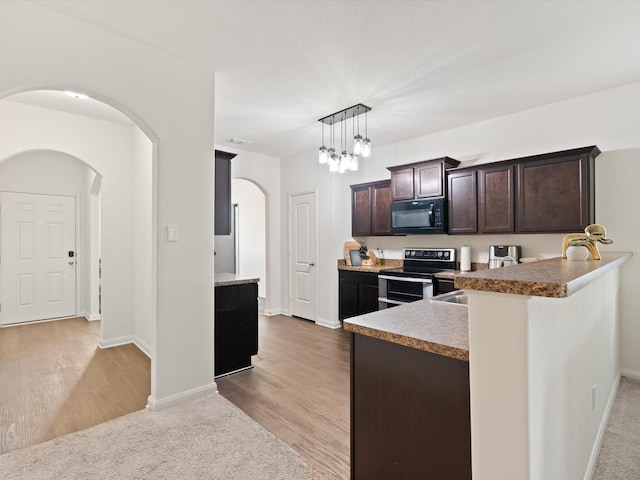 14157 Stallion Ridge Dr, Dallas, TX 75253 - kitchen with double oven range, a peninsula, arched walkways, dark brown cabinetry, and black microwave
