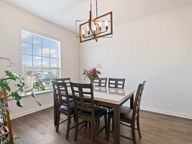 dining area with baseboards, a chandelier, and dark wood-style flooring