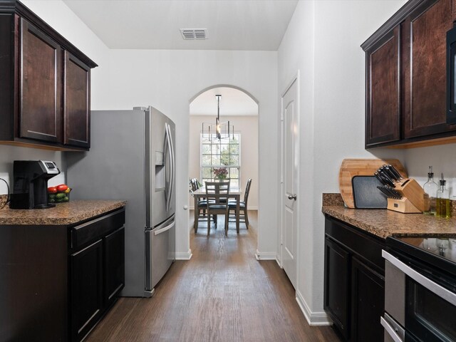 14157 Stallion Ridge Dr, Dallas, TX 75253 - kitchen with dark wood finished floors, dark brown cabinets, arched walkways, and visible vents