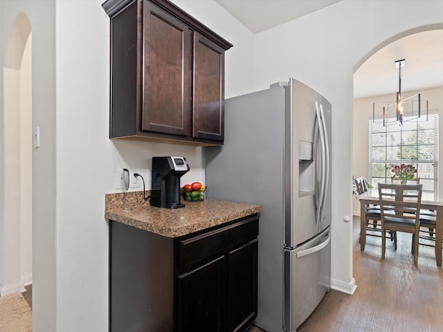 14157 Stallion Ridge Dr, Dallas, TX 75253 - kitchen featuring dark brown cabinets, baseboards, stainless steel refrigerator with ice dispenser, wood finished floors, and arched walkways
