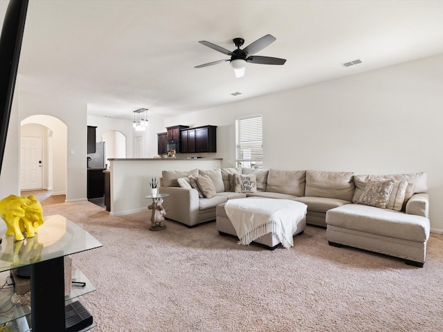14157 Stallion Ridge Dr, Dallas, TX 75253 - living area with visible vents, arched walkways, baseboards, light colored carpet, and ceiling fan