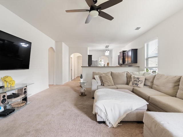 14157 Stallion Ridge Dr, Dallas, TX 75253 - living area featuring a ceiling fan, visible vents, arched walkways, and light carpet
