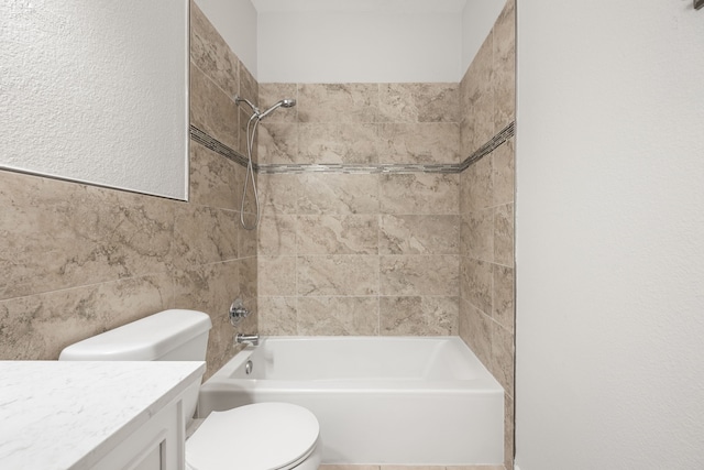 full bath with shower / bathing tub combination, toilet, tile walls, and vanity