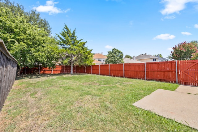 view of yard featuring a patio and a fenced backyard