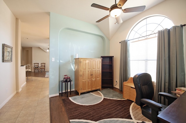 home office featuring vaulted ceiling, a ceiling fan, and baseboards