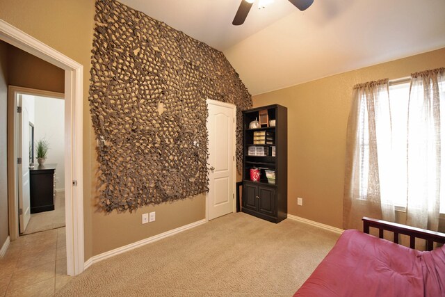 bedroom featuring light colored carpet, vaulted ceiling, multiple windows, and baseboards