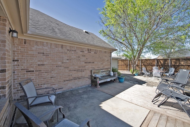 view of patio featuring a fenced backyard and a deck
