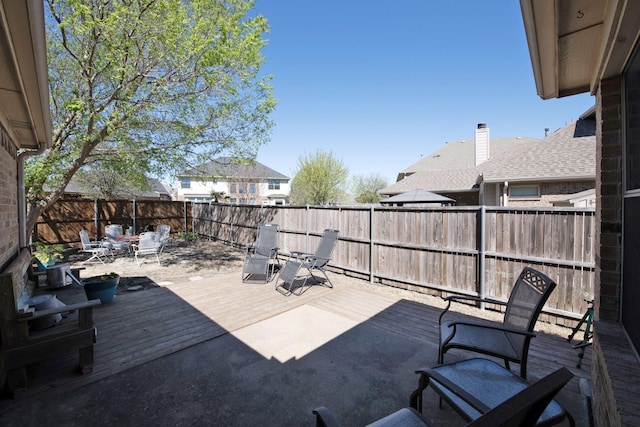 view of patio / terrace with a fenced backyard, a deck, and outdoor dining area