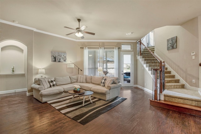 living room with wood finished floors, visible vents, baseboards, stairs, and crown molding