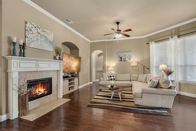 living area with visible vents, baseboards, dark wood-style floors, and a tile fireplace