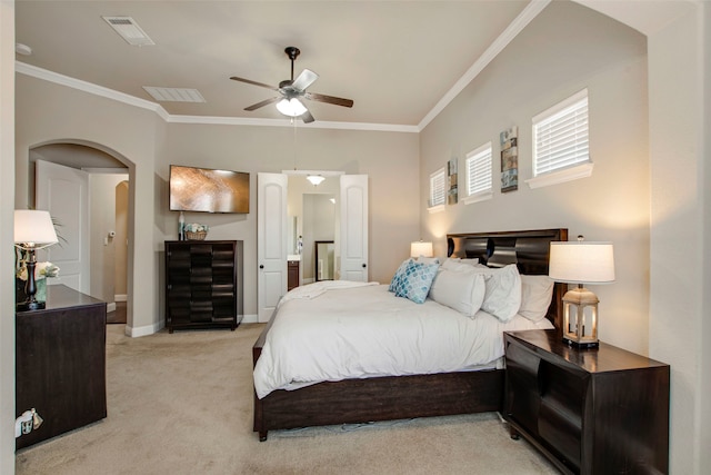 bedroom with visible vents, arched walkways, light colored carpet, and ornamental molding