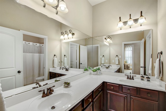 full bath with double vanity, a shower with curtain, and a sink