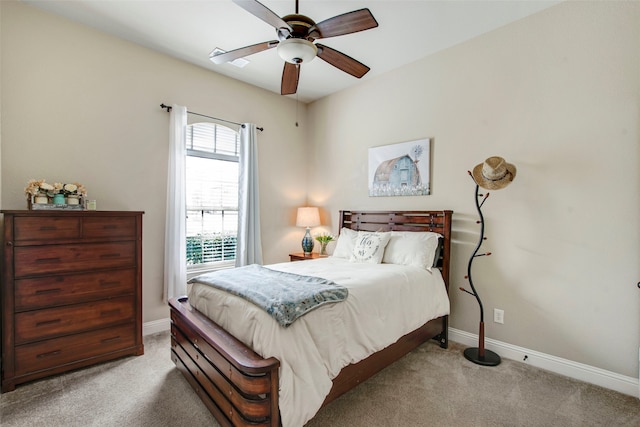 carpeted bedroom featuring ceiling fan and baseboards