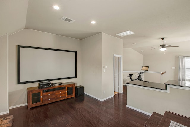 cinema room with wood finished floors, visible vents, baseboards, recessed lighting, and vaulted ceiling