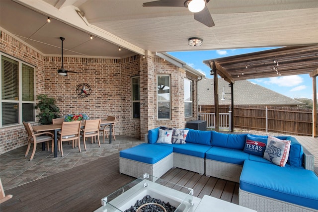 view of patio featuring outdoor dining space, an outdoor living space, a wooden deck, and fence