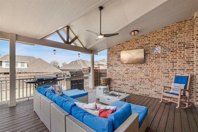 deck featuring a grill, an outdoor hangout area, a ceiling fan, and fence