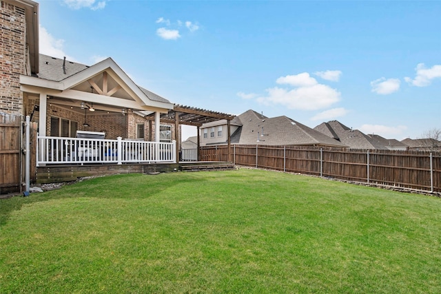 view of yard with a fenced backyard, a ceiling fan, and a pergola