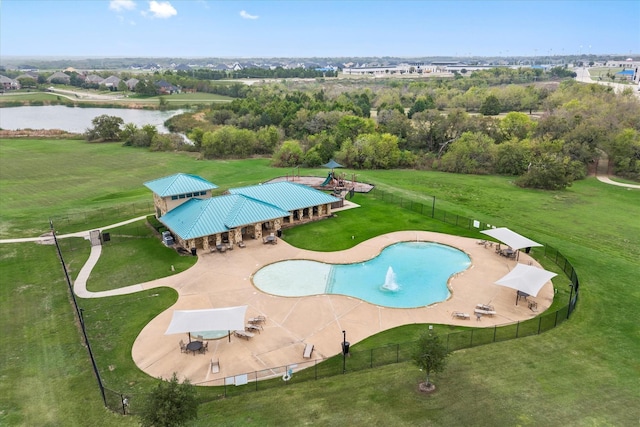 view of swimming pool with a yard, a water view, a patio, and fence