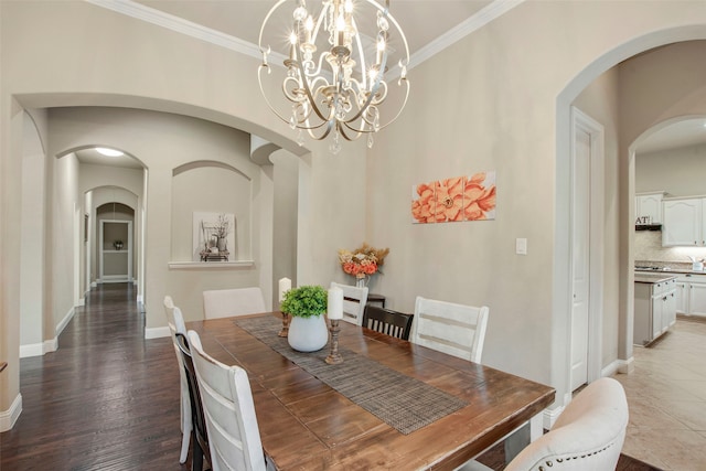 dining space with wood finished floors, baseboards, and ornamental molding