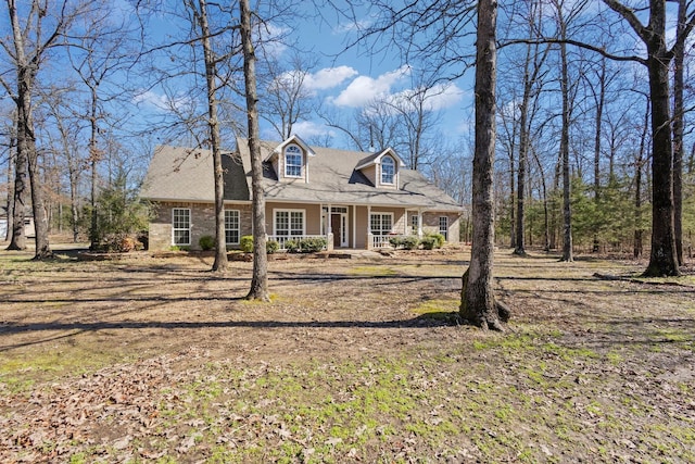 new england style home featuring covered porch