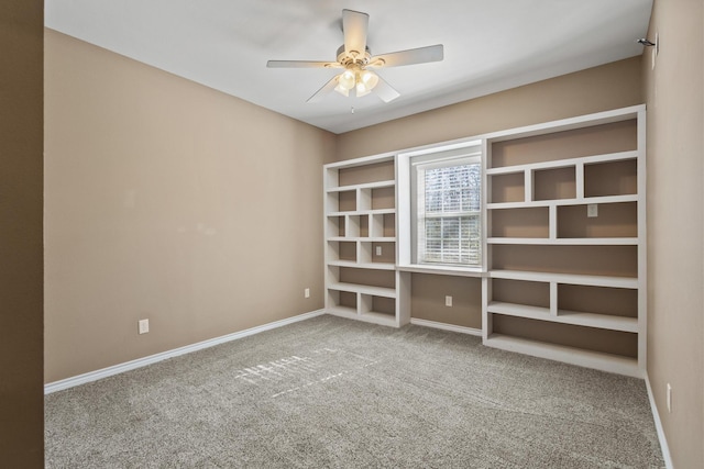 unfurnished room with baseboards, carpet floors, and a ceiling fan