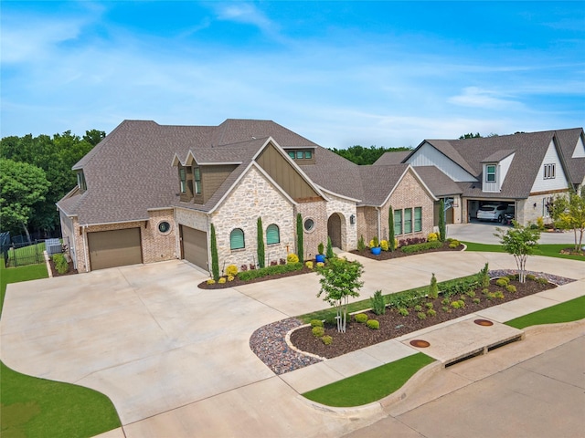 view of front of house featuring brick siding, board and batten siding, concrete driveway, and roof with shingles