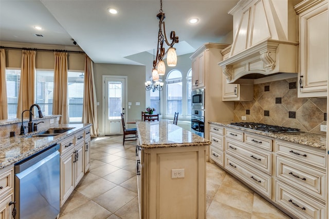 kitchen featuring custom exhaust hood, a sink, cream cabinetry, appliances with stainless steel finishes, and a center island