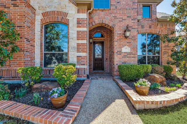 property entrance featuring brick siding