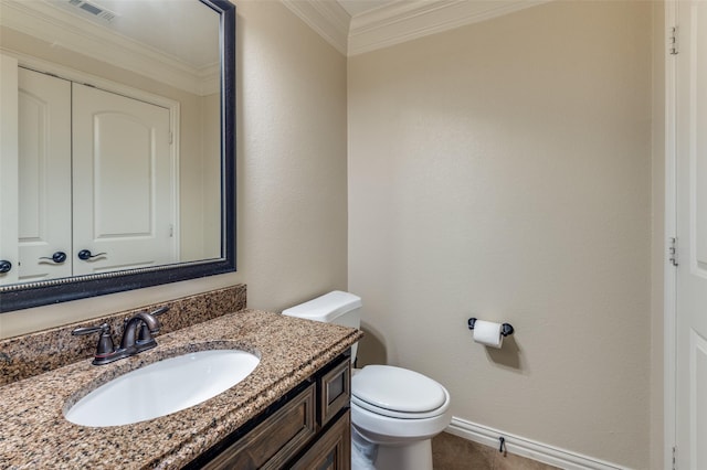 bathroom featuring vanity, baseboards, visible vents, ornamental molding, and toilet