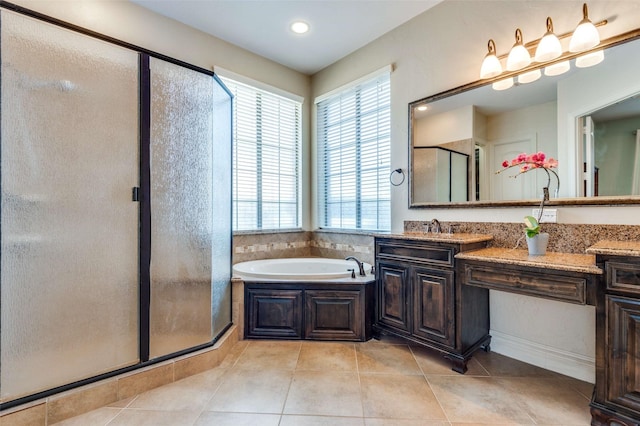 full bathroom featuring tile patterned flooring, a bath, vanity, and a stall shower