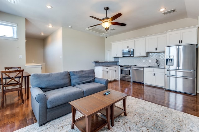 living room featuring visible vents, recessed lighting, a ceiling fan, and dark wood-style flooring