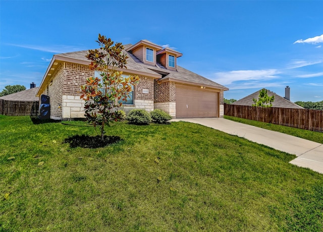 view of front of property featuring fence, driveway, a front lawn, a garage, and brick siding