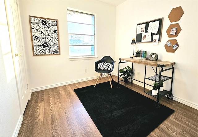 living area with wood finished floors and baseboards
