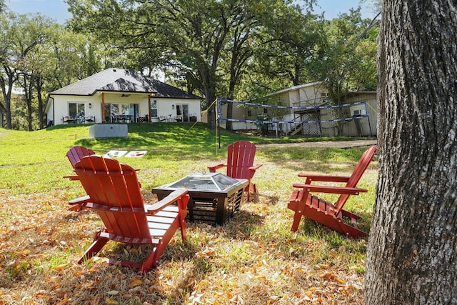 view of yard featuring a fire pit and ceiling fan