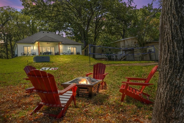 view of yard with a fire pit and a trampoline