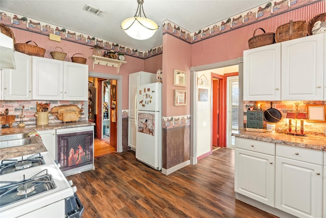 kitchen featuring dark wood-style floors, white appliances, white cabinets, backsplash, and visible vents