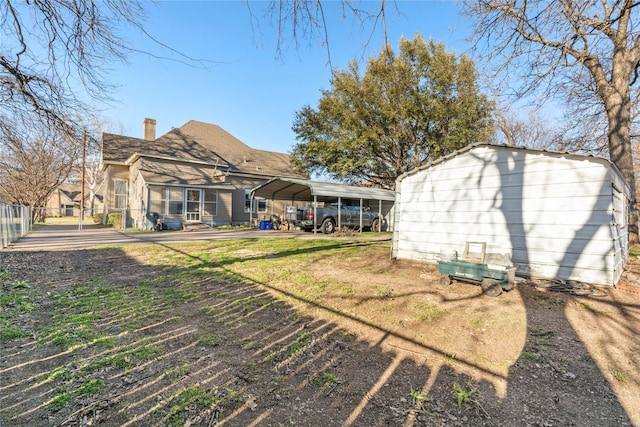 view of yard with a detached carport and fence