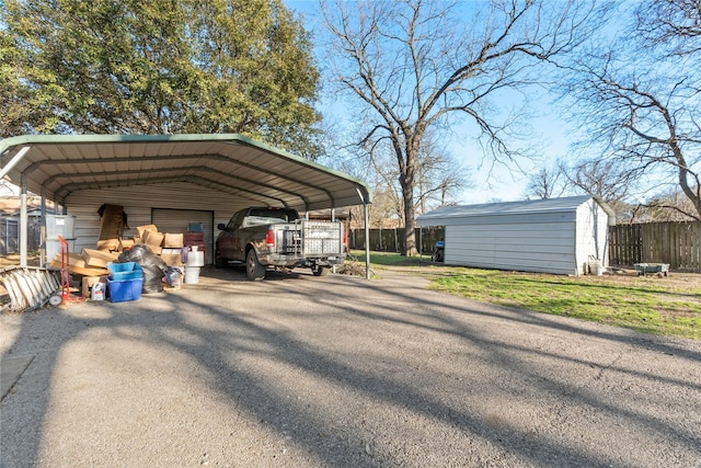 view of parking / parking lot with fence and a shed