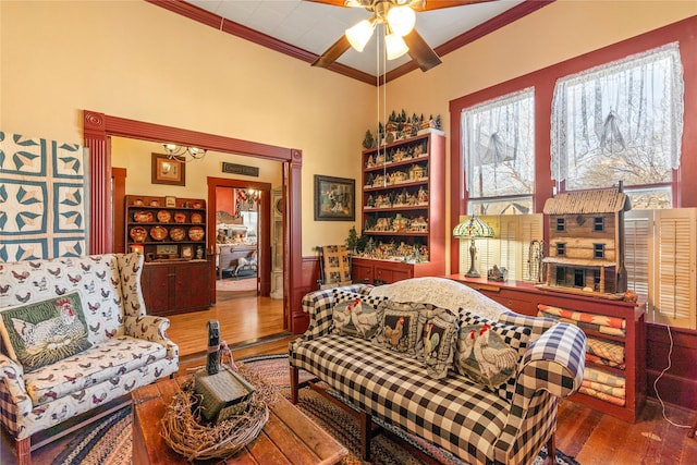 interior space featuring ceiling fan, a healthy amount of sunlight, hardwood / wood-style flooring, and ornamental molding