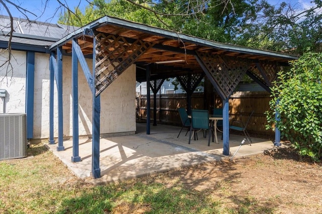 view of patio with fence and central AC